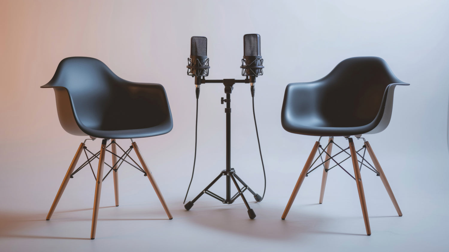 Two chairs, each with a microphone pointing towards them, to signify the recording of the Tides of Business Podcast.